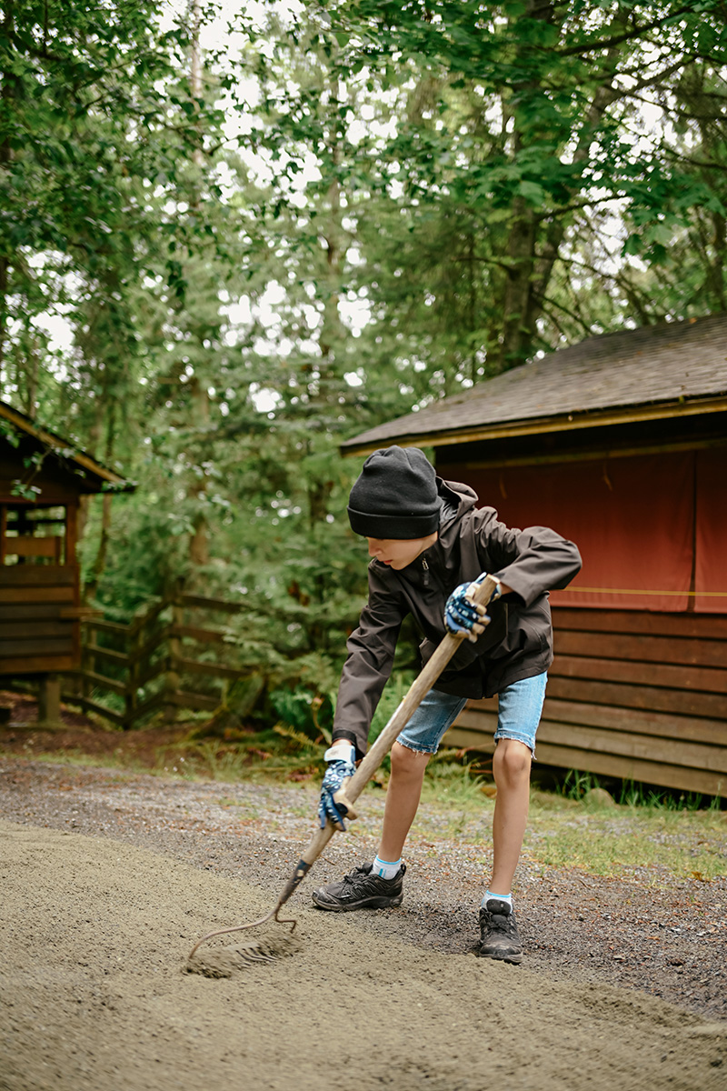 Attendee Raking the Ground