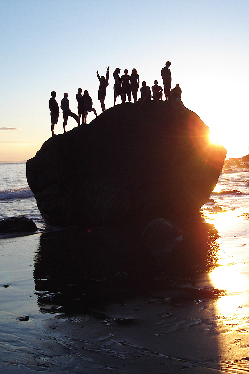 Kaléo Students on Rock at Beach at Sunset
