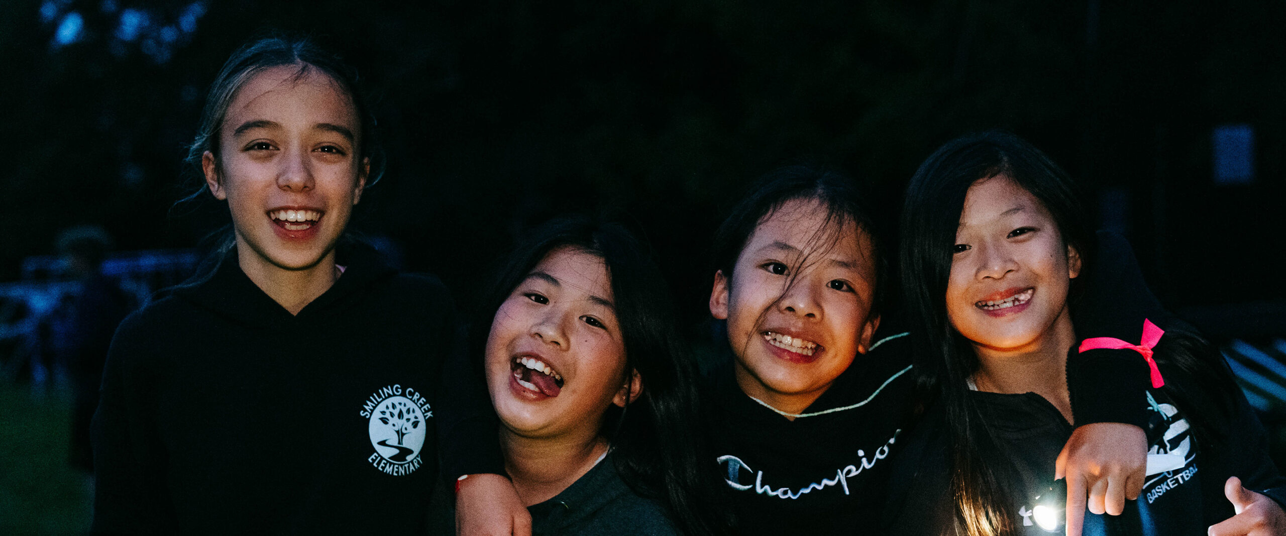 Smiling Campers During Night Game